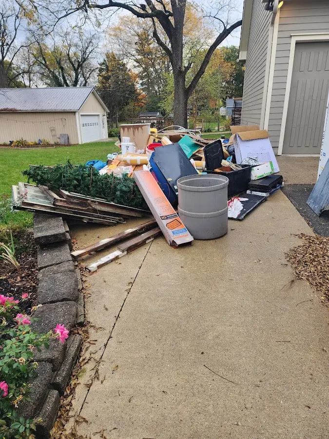 Dumpster being loaded with debris for Roofing Dumpster Rental in Midway North